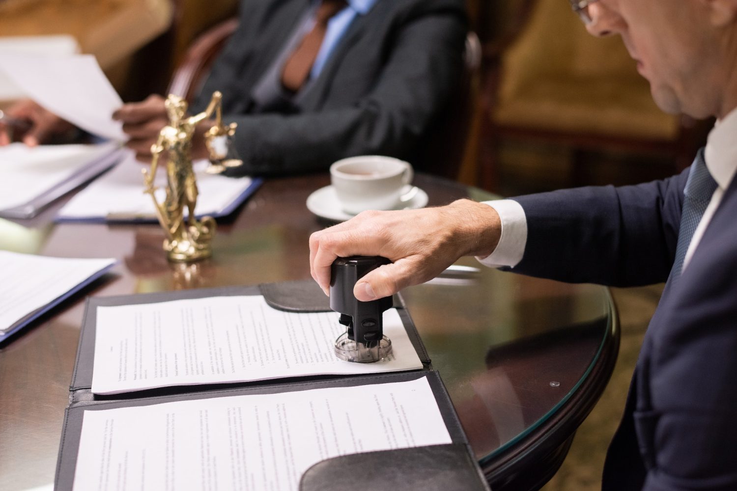 hand-of-director-of-company-putting-stamp-on-document.jpg hand-of-director-of-company-putting-stamp-on-document.jpg